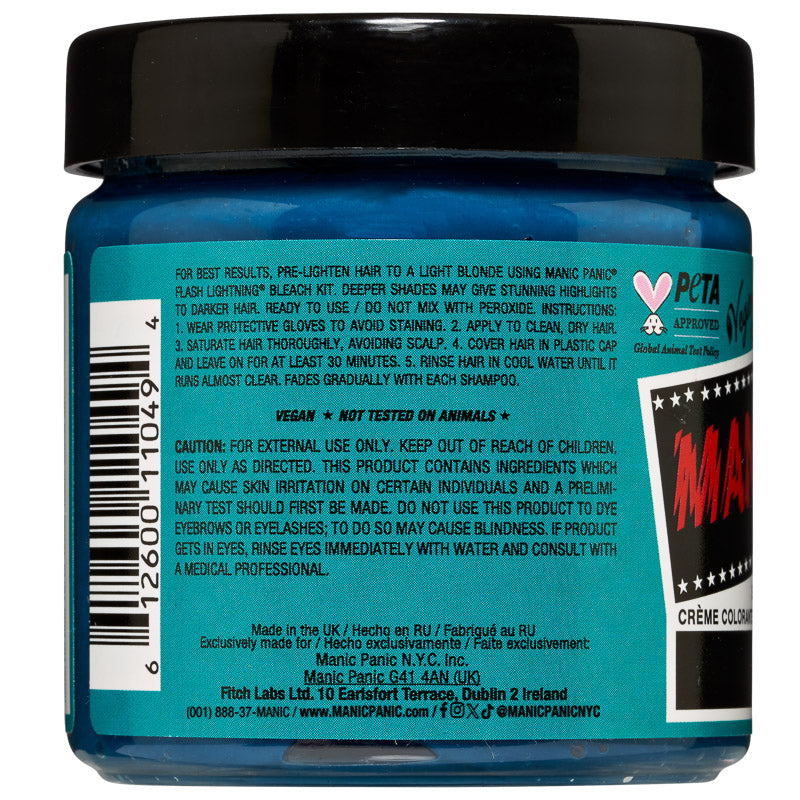Back view of a blue hair color cream jar with a black lid, showing extensive product information, ingredients, and a red and white 'M' logo on a teal label.